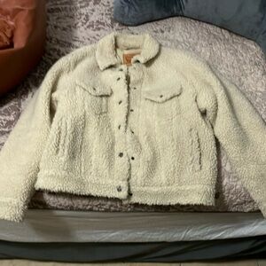 Levi Strauss size medium cream colored button up coat.
